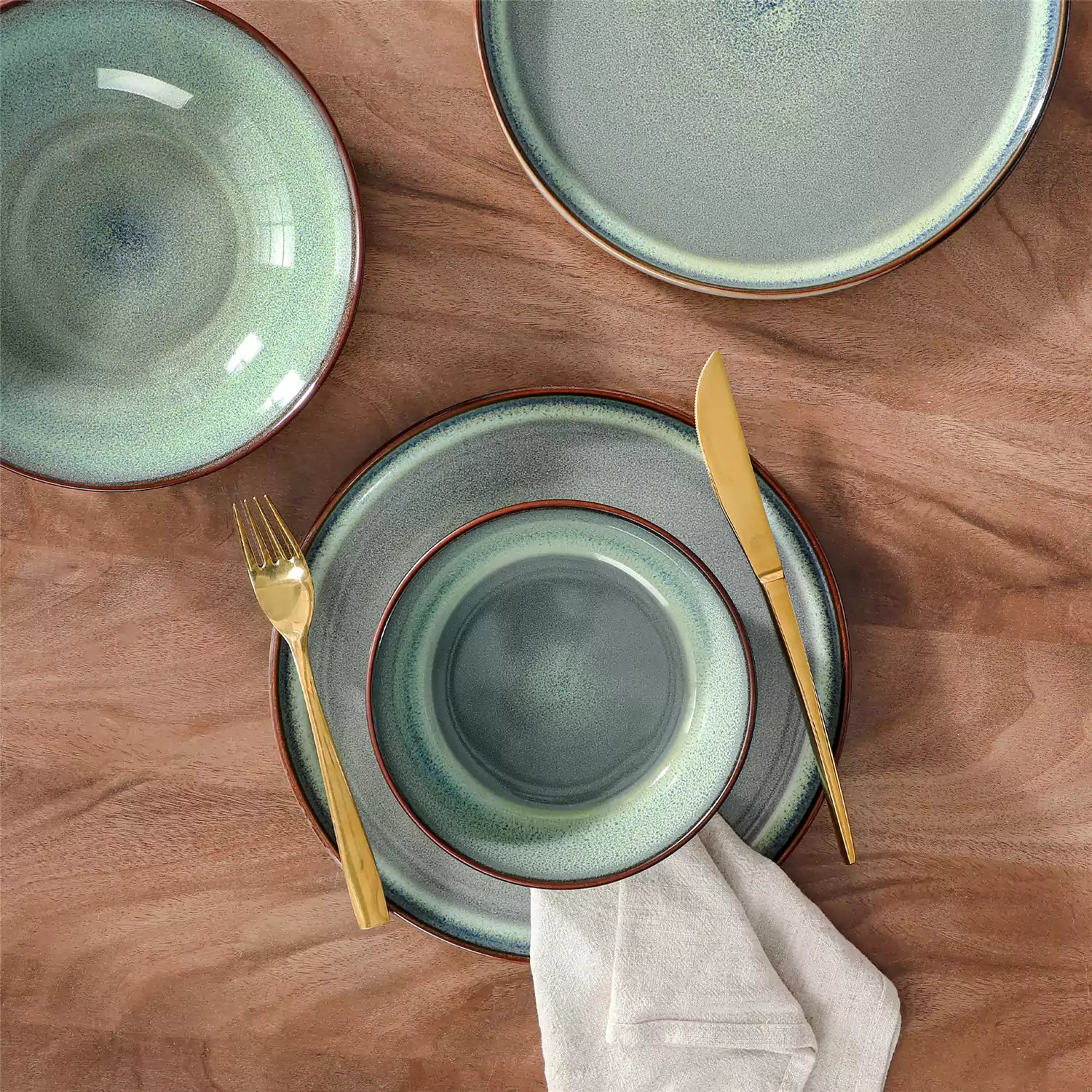 Sata green stoneware dinnerware set styled dining table with dinner plates salad plates pasta bowls cereal bowls silverware and floral centerpiece farmhouse reactive glaze service for 6