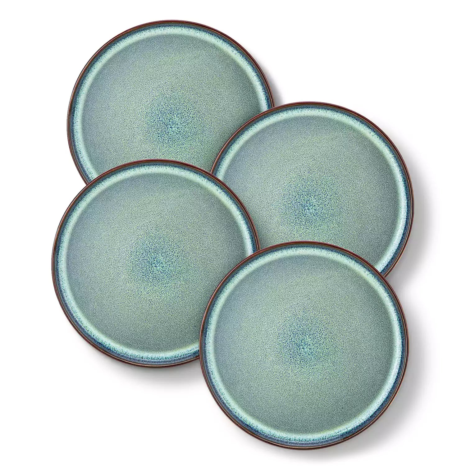 Sata green stoneware dinner plate set of 4 styled with lamb chops and vegetables on a dinner table farmhouse lipped edge reactive glaze one of a kind finish