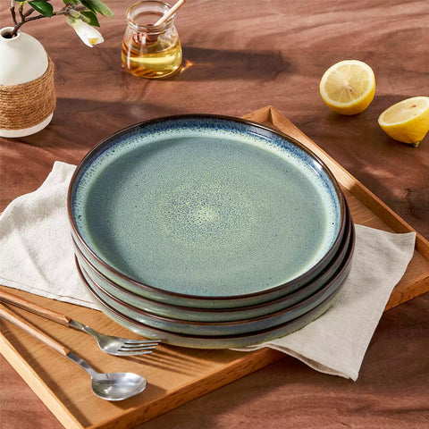 Sata green stoneware dinner plate set of 4 styled with lamb chops and vegetables on a dinner table farmhouse lipped edge reactive glaze one of a kind finish