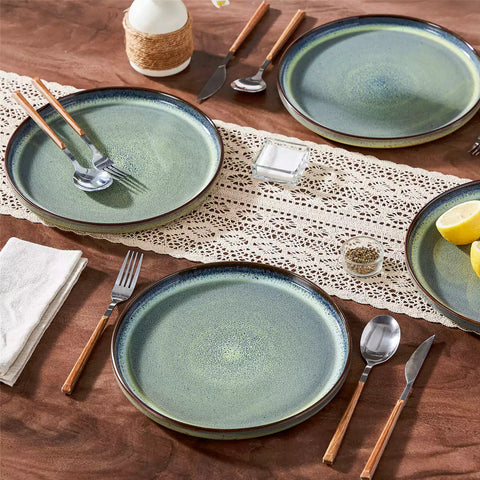 Sata green stoneware dinner plate set of 4 styled with lamb chops and vegetables on a dinner table farmhouse lipped edge reactive glaze one of a kind finish