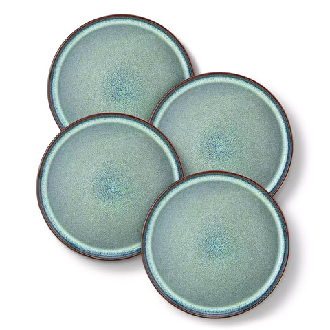 Sata green stoneware dinner plate set of 4 styled with lamb chops and vegetables on a dinner table farmhouse lipped edge reactive glaze one of a kind finish
