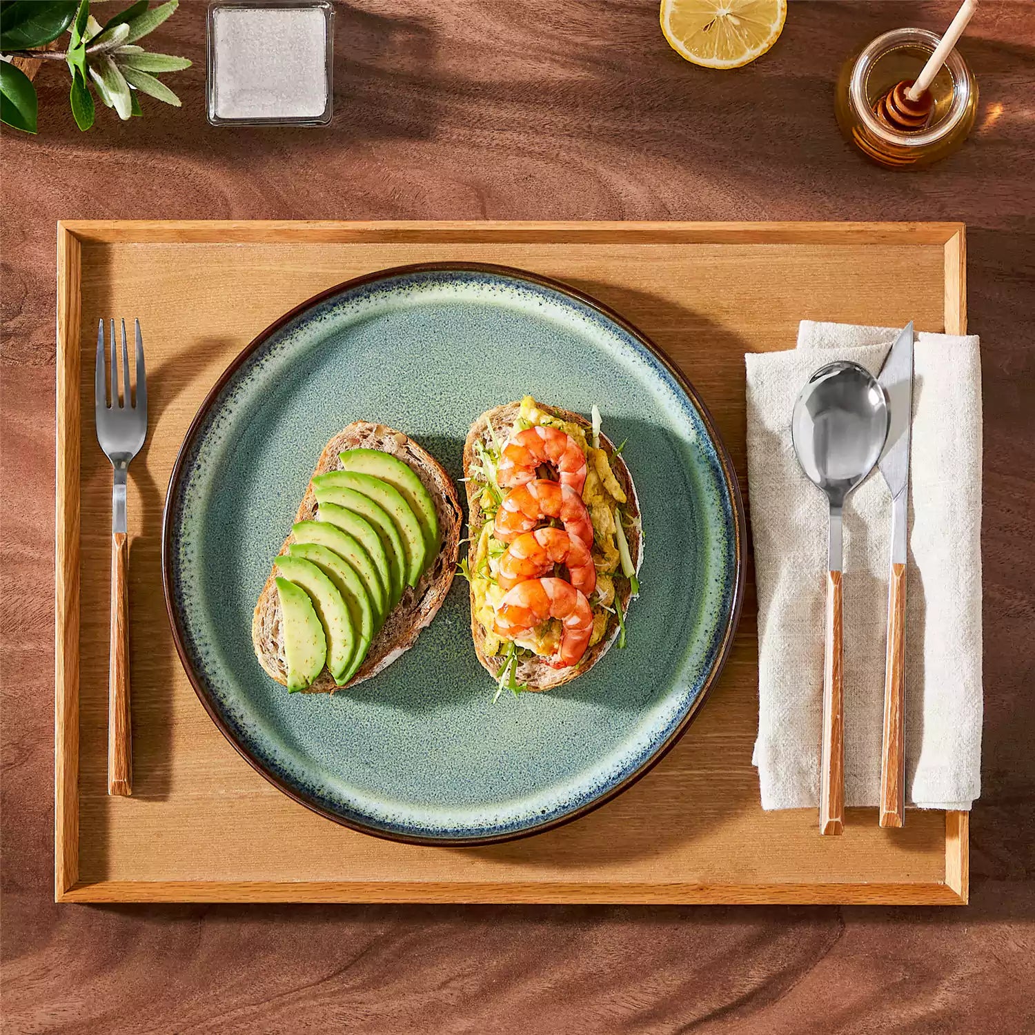 Sata green stoneware dinner plate set of 4 styled with lamb chops and vegetables on a dinner table farmhouse lipped edge reactive glaze one of a kind finish