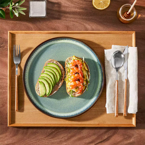 Sata green stoneware dinner plate set of 4 styled with lamb chops and vegetables on a dinner table farmhouse lipped edge reactive glaze one of a kind finish