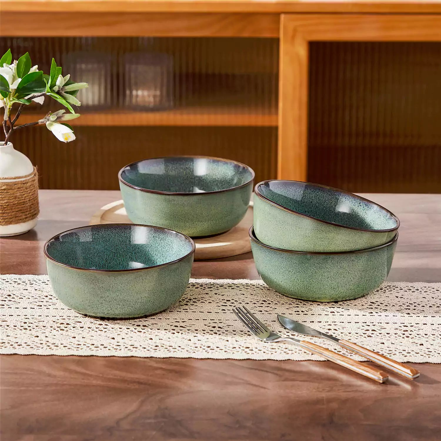 Sata green stoneware cereal bowls set of 4 with assorted meals styled on a wooden table with lace tablecloth farmhouse reactive glaze lipped edge artisan finish