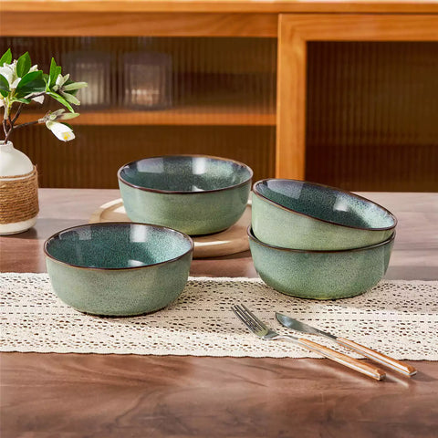 Sata green stoneware cereal bowls set of 4 with assorted meals styled on a wooden table with lace tablecloth farmhouse reactive glaze lipped edge artisan finish