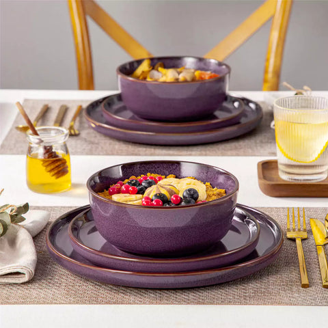 Sata purple stoneware 12 piece dinnerware set with dinner plates salad plates and cereal bowls styled with gold cutlery on textured surface farmhouse reactive glaze lipped edge service for 4