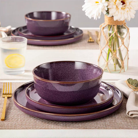 Sata purple stoneware 12 piece dinnerware set with dinner plates salad plates and cereal bowls styled with gold cutlery on textured surface farmhouse reactive glaze lipped edge service for 4