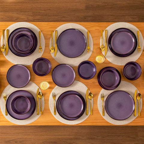 Sata purple stoneware 18 piece dinnerware set with dinner plates salad plates and cereal bowls styled on a wooden table with diverse meal setup farmhouse reactive glaze lipped edge service for 6