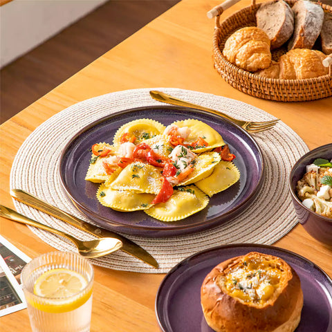 Sata purple stoneware 18 piece dinnerware set with dinner plates salad plates and cereal bowls styled on a wooden table with diverse meal setup farmhouse reactive glaze lipped edge service for 6