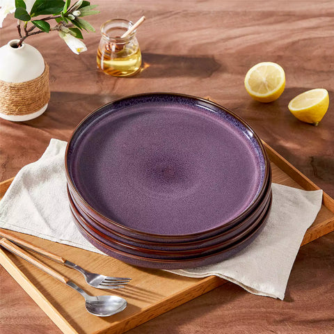 Sata purple stoneware dinner plate set of 4 styled with lamb chops and vegetables on a dinner table farmhouse lipped edge reactive glaze one of a kind finish