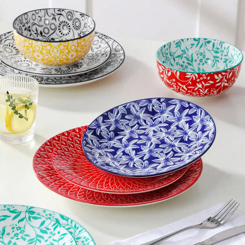 Selene porcelain 12 piece dinnerware set service for 4 vibrant floral geometric plates bowls flat lay with cutlery