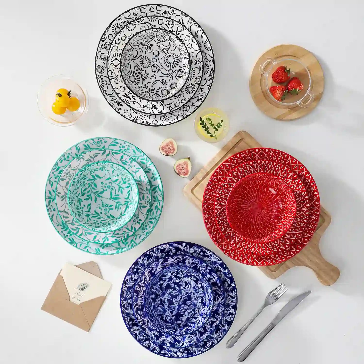 Selene porcelain 12 piece dinnerware set service for 4 vibrant floral geometric plates bowls flat lay with cutlery