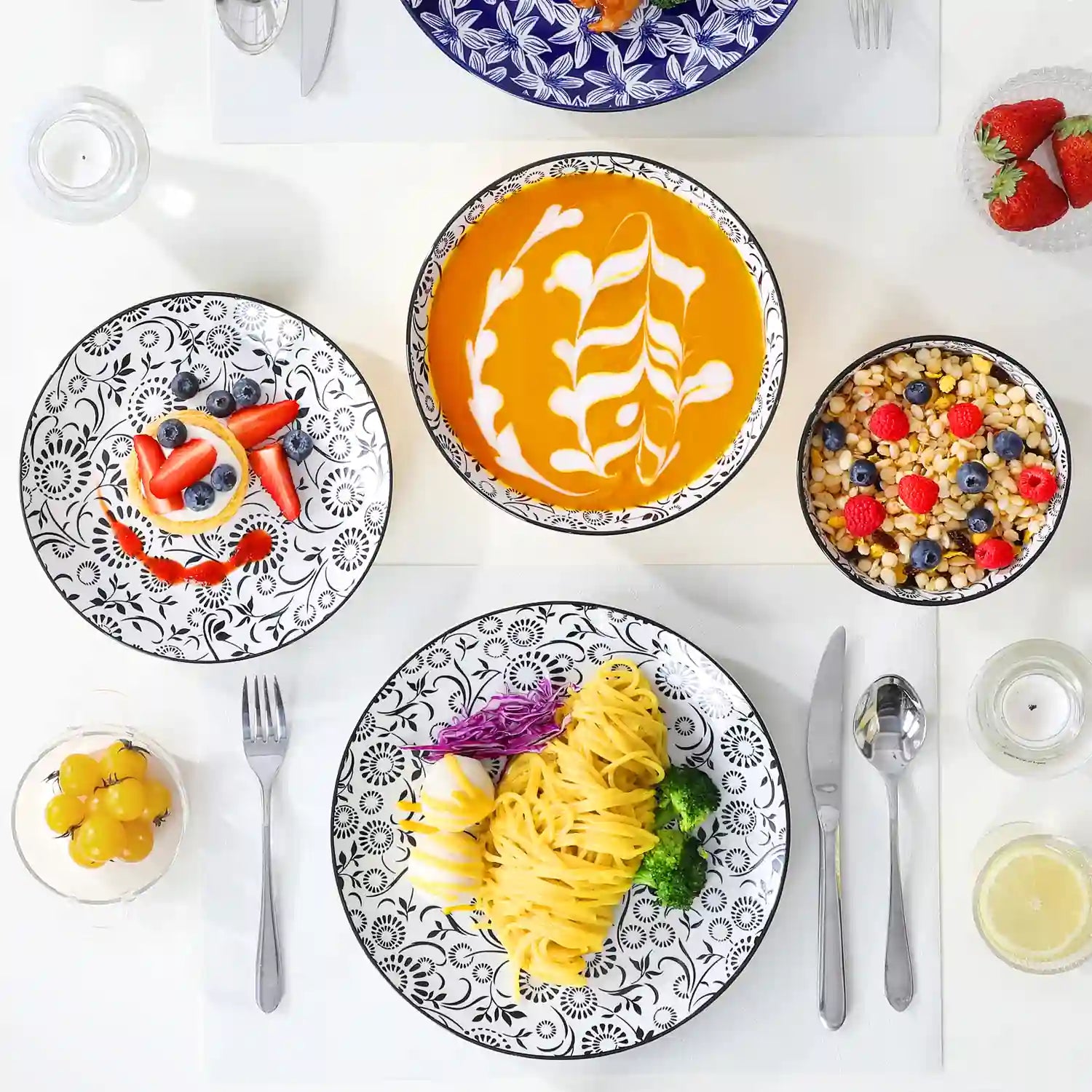 Selene porcelain 24 piece dinnerware set vibrant floral leaf pattern plates lifestyle serving scene with food