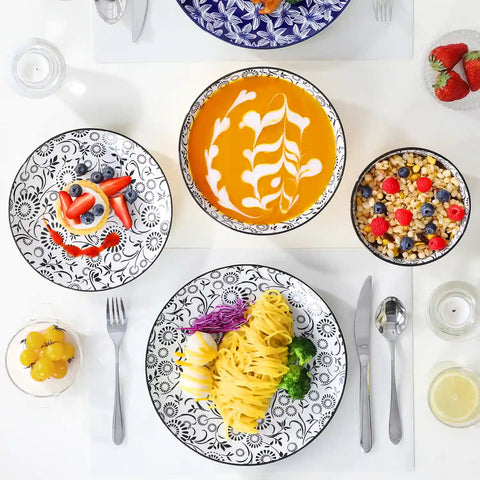 Selene porcelain 24 piece dinnerware set vibrant floral leaf pattern plates lifestyle serving scene with food