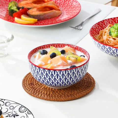 Selene porcelain 24 piece dinnerware set vibrant floral leaf pattern plates lifestyle serving scene with food