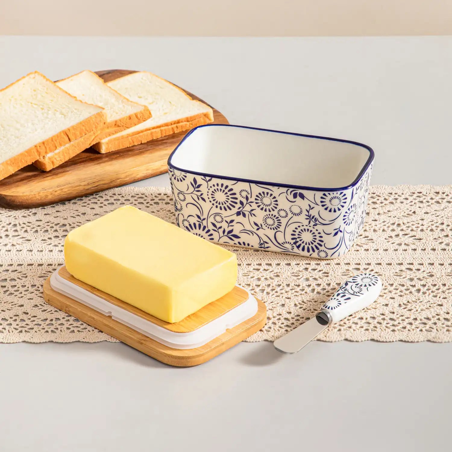 Selene porcelain butter dish Sol pattern with wood lid tabletop scene with bread and fruit