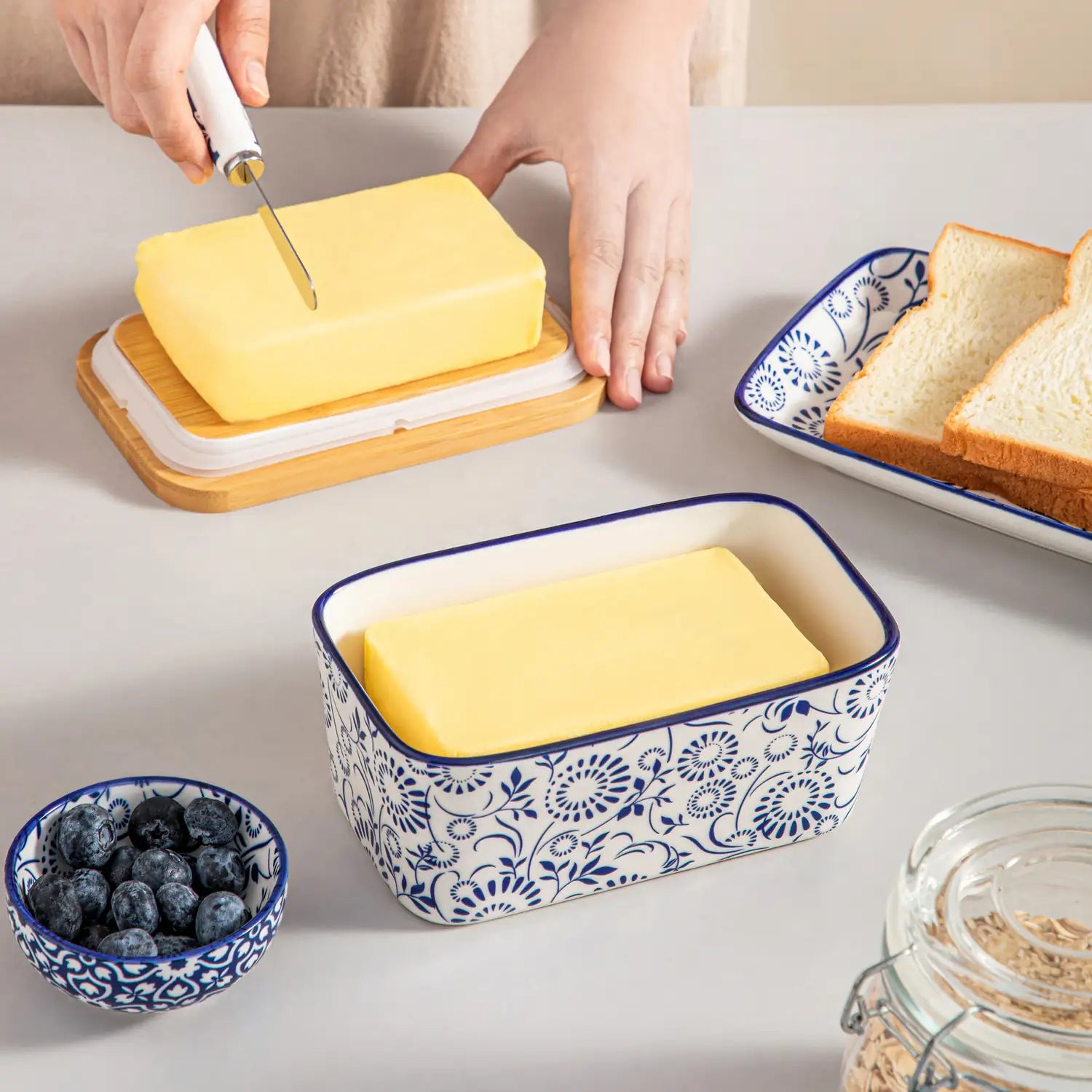 Selene porcelain butter dish Sol pattern with wood lid tabletop scene with bread and fruit