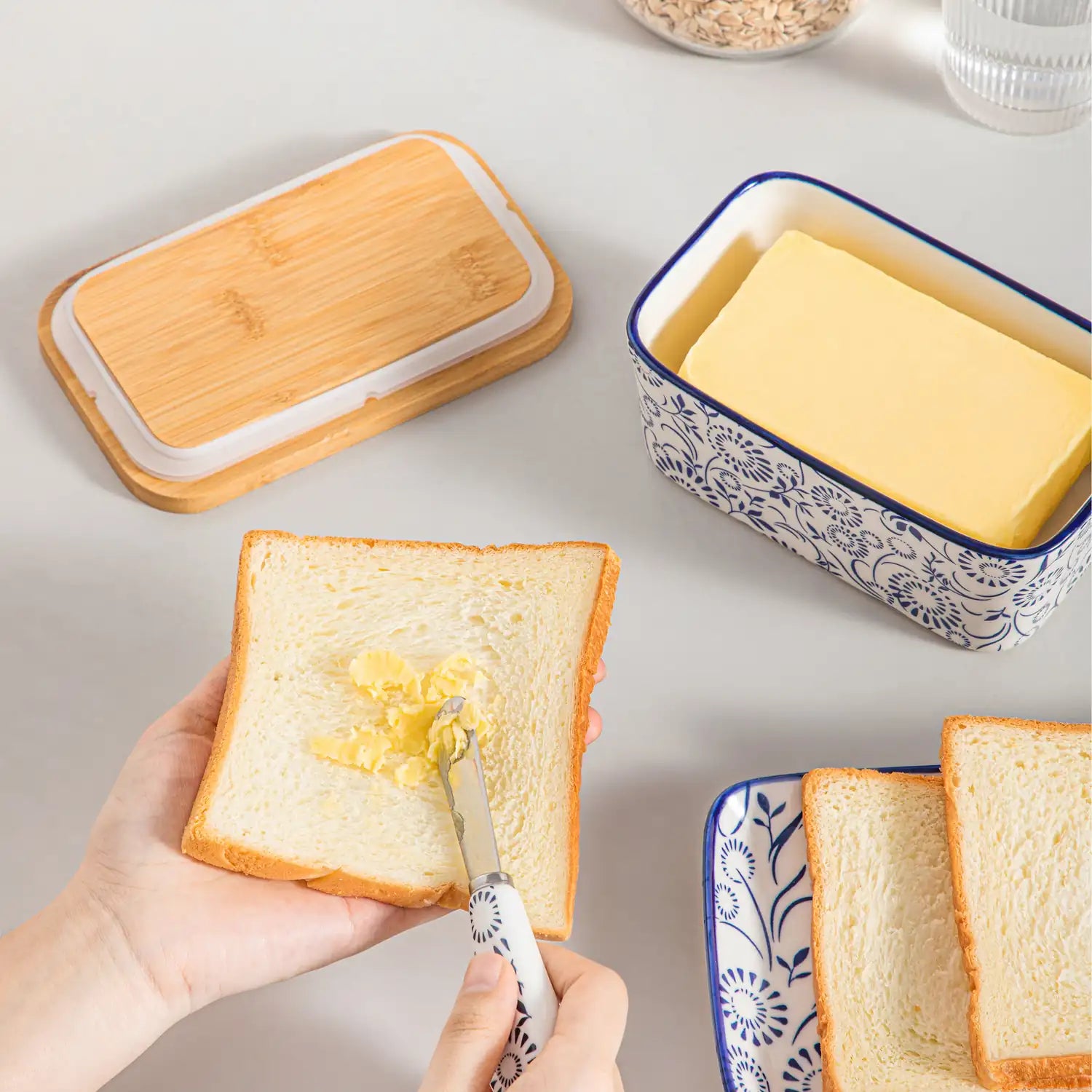 Selene porcelain butter dish Sol pattern with wood lid tabletop scene with bread and fruit