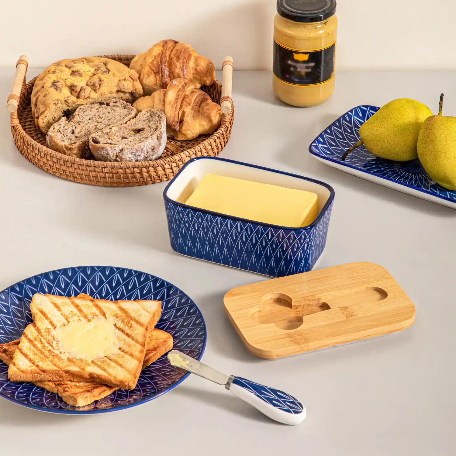 Selene porcelain butter dish Flame pattern with wood lid tabletop scene with bread and fruit