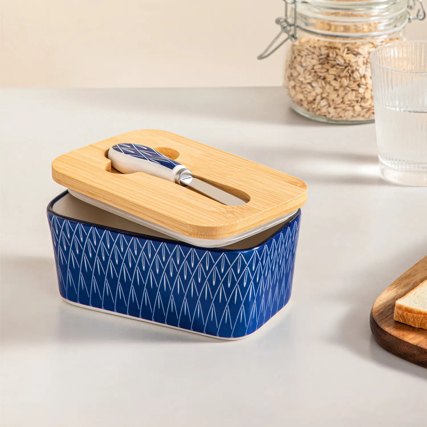 Selene porcelain butter dish Flame pattern with wood lid tabletop scene with bread and fruit