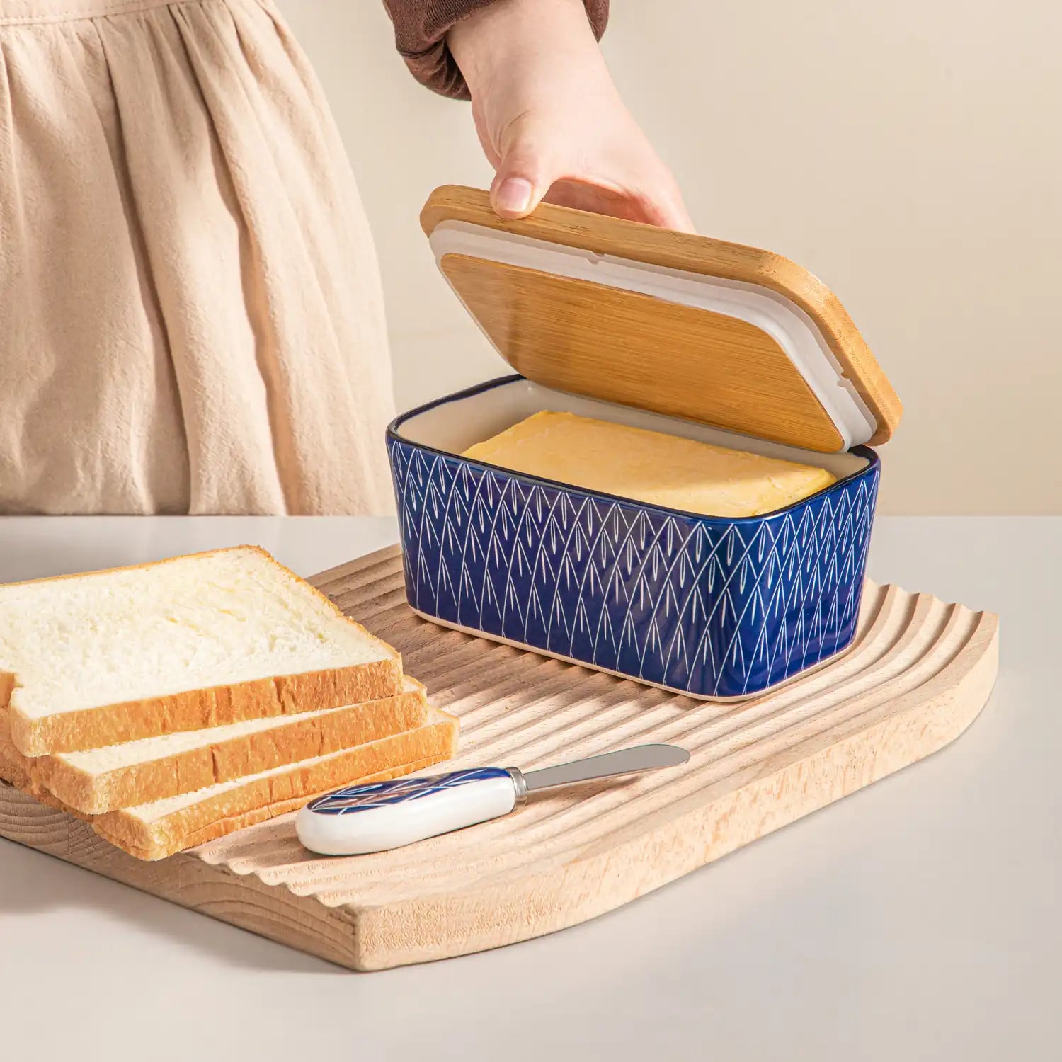 Selene porcelain butter dish Flame pattern with wood lid tabletop scene with bread and fruit