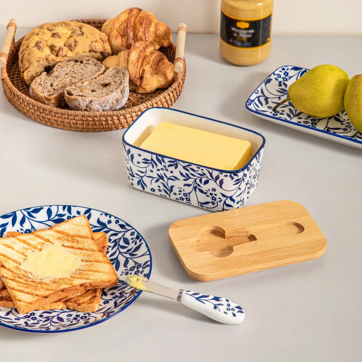 Selene porcelain butter dish Vine pattern with wood lid tabletop scene with bread and fruit