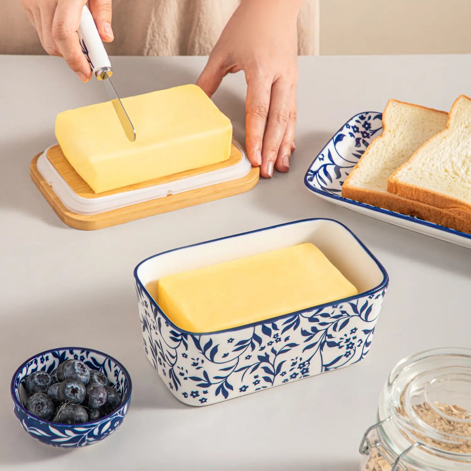 Selene porcelain butter dish Vine pattern with wood lid tabletop scene with bread and fruit