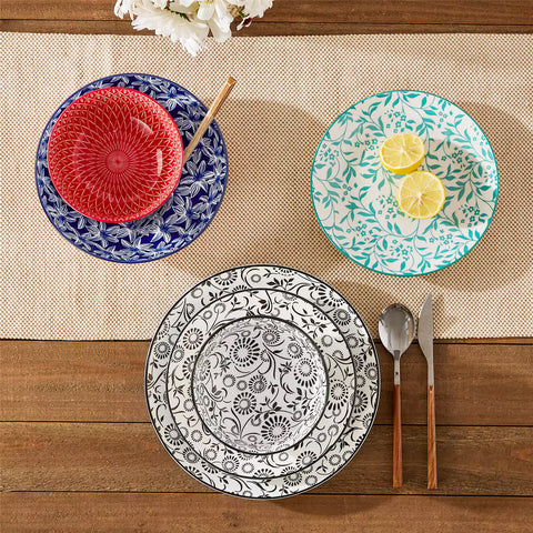 16 piece Japanese porcelain dinnerware set with indigo and earth tone floral geometric patterns on white ceramic plates and bowls