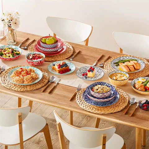 16 piece Japanese porcelain dinnerware set with indigo and earth tone floral geometric patterns on white ceramic plates and bowls