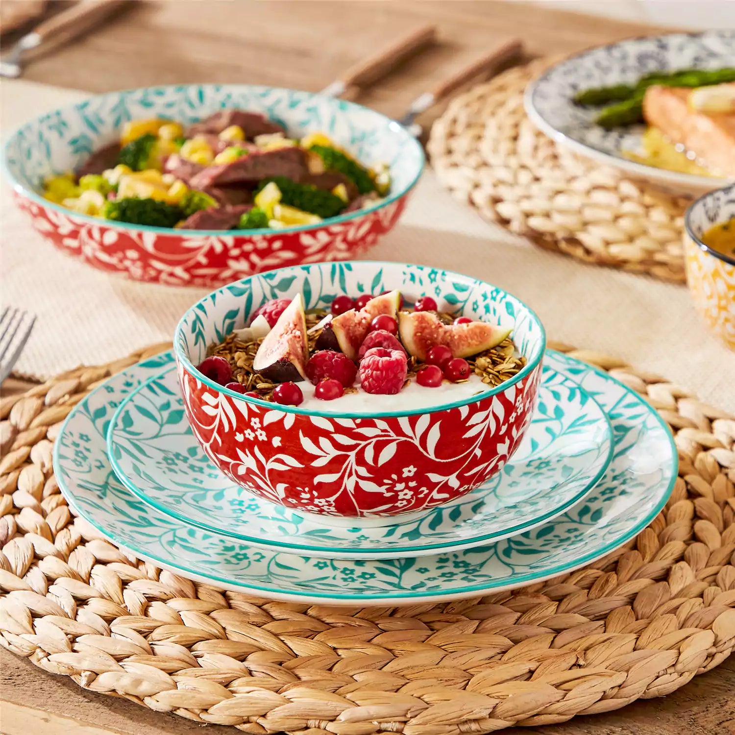 16 piece Japanese porcelain dinnerware set with indigo and earth tone floral geometric patterns on white ceramic plates and bowls