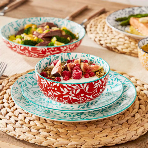 16 piece Japanese porcelain dinnerware set with indigo and earth tone floral geometric patterns on white ceramic plates and bowls