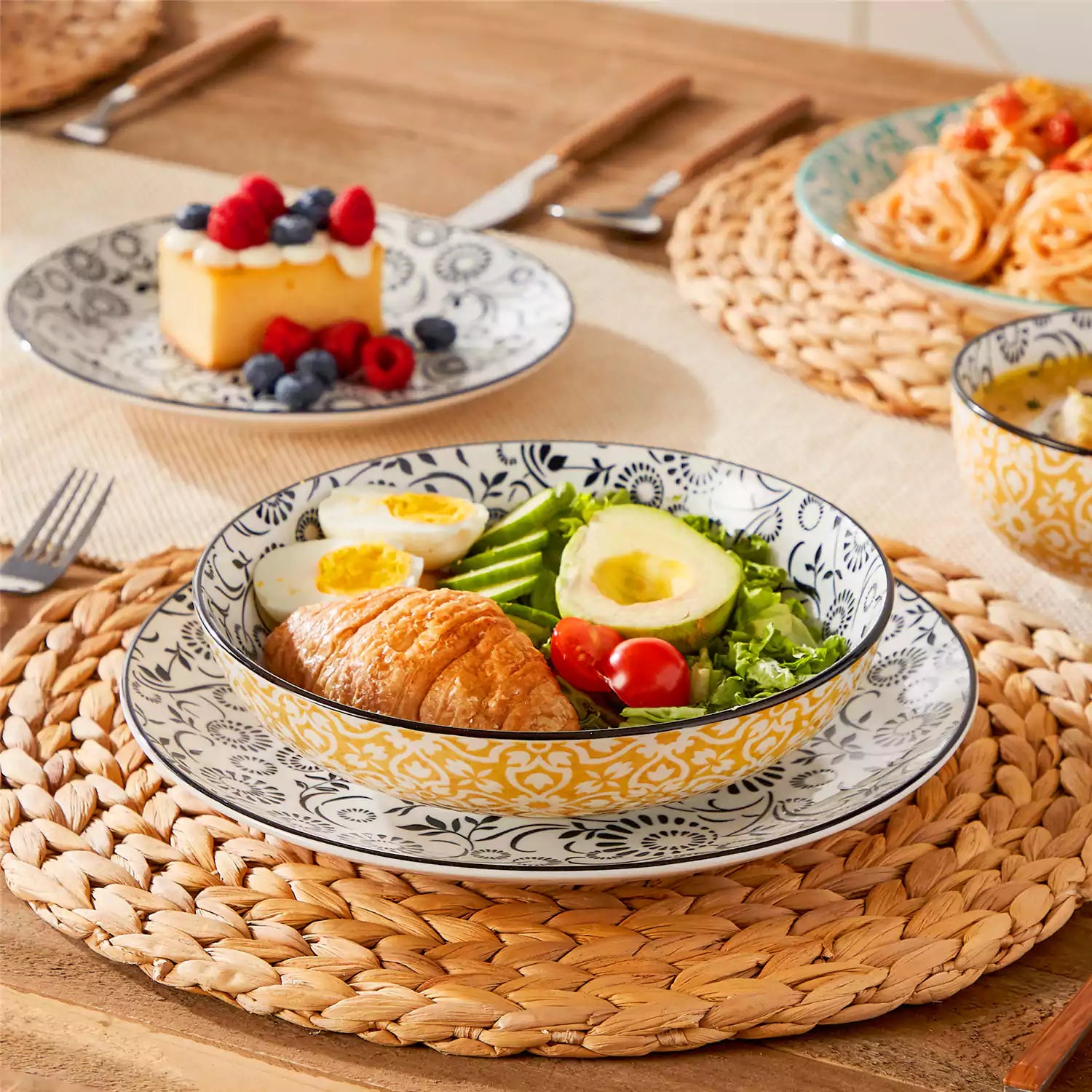 16 piece Japanese porcelain dinnerware set with indigo and earth tone floral geometric patterns on white ceramic plates and bowls