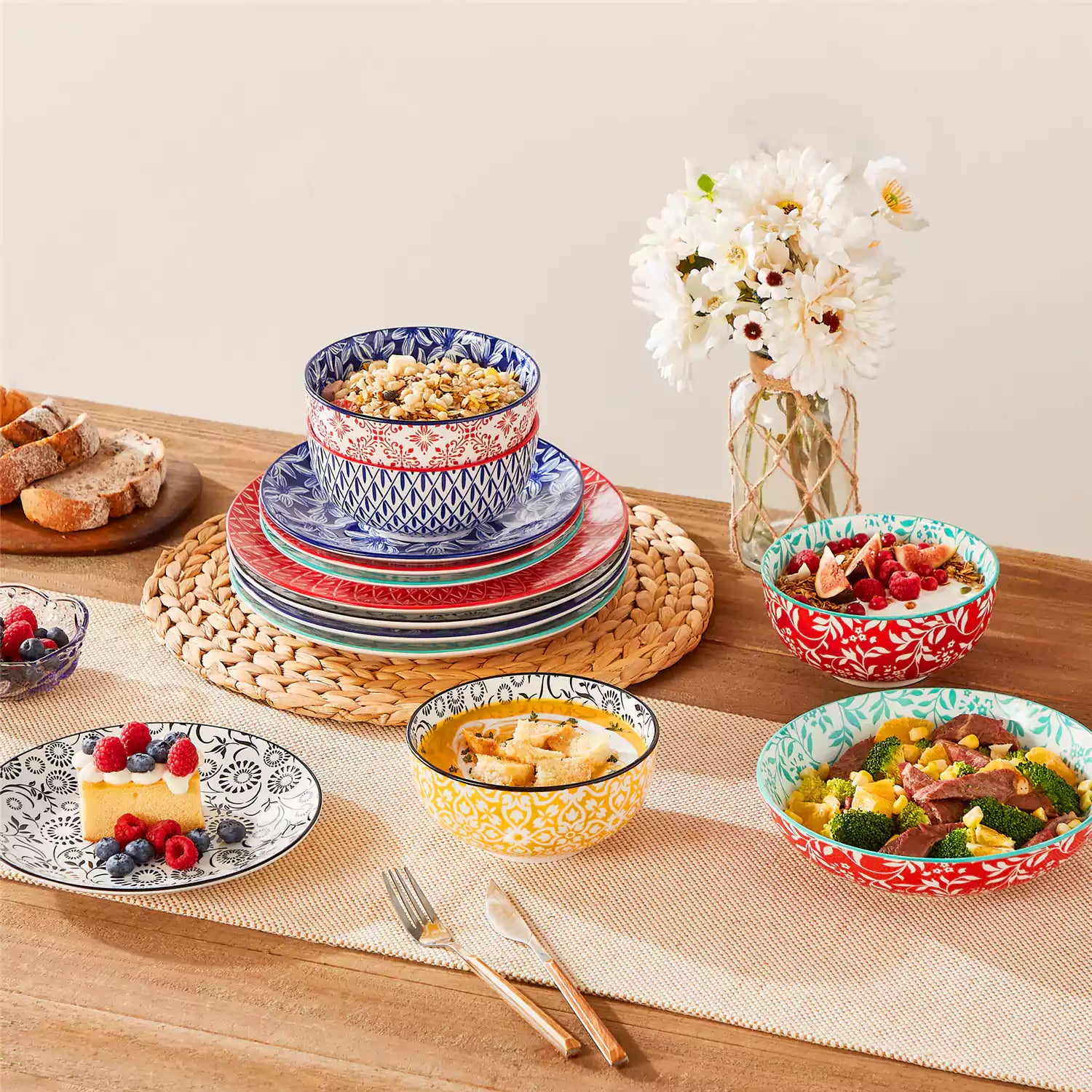 16 piece Japanese porcelain dinnerware set with indigo and earth tone floral geometric patterns on white ceramic plates and bowls