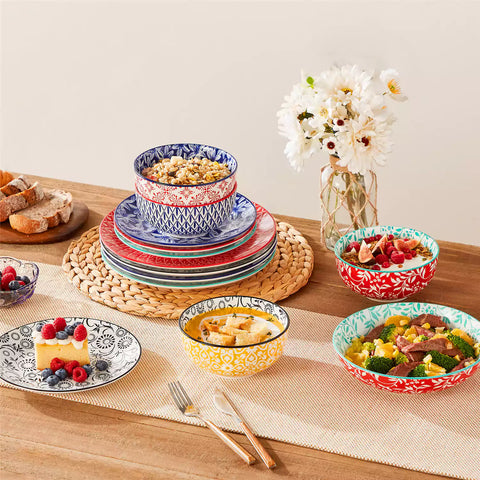 16 piece Japanese porcelain dinnerware set with indigo and earth tone floral geometric patterns on white ceramic plates and bowls