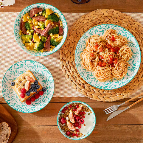 16 piece Japanese porcelain dinnerware set with indigo and earth tone floral geometric patterns on white ceramic plates and bowls