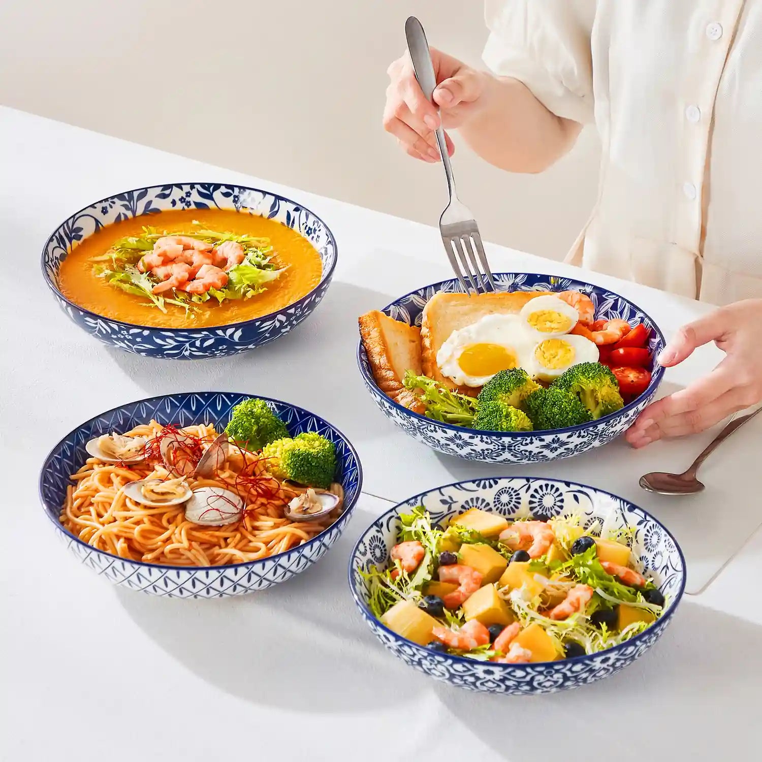 Selene porcelain indigo pasta bowls set of 4 blue white floral Japanese-inspired tabletop scene with food