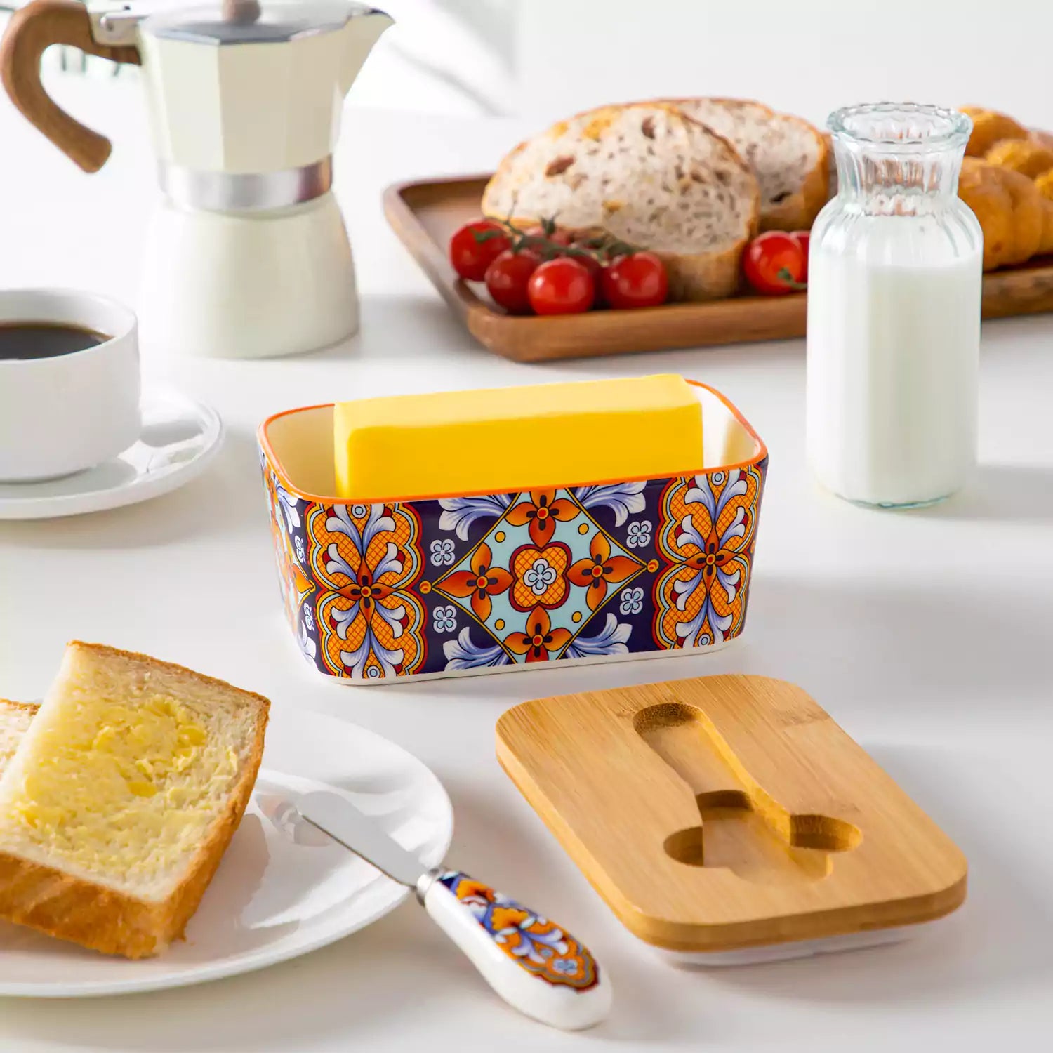 Bold orange porcelain butter dish with wooden lid in boho chic style - perfect for a colorful breakfast table with bread and coffee-vancasso