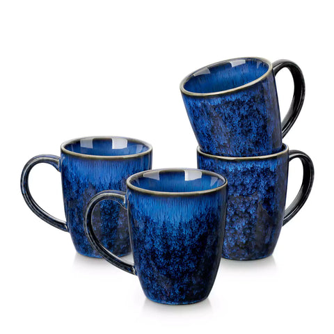 Blue Starry 12oz stoneware mugs set of 4 with reactive glaze finish on a kitchen counter with coffee milk and fresh bread