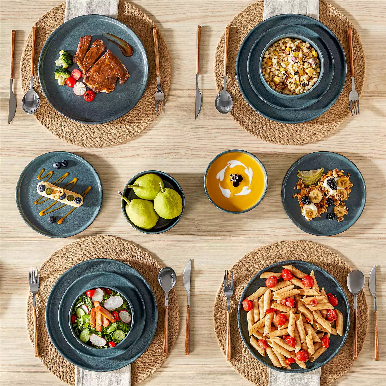Blue reactive glaze stoneware dinner plates styled with food on rustic wood table with woven placemats modern minimalist tableware set